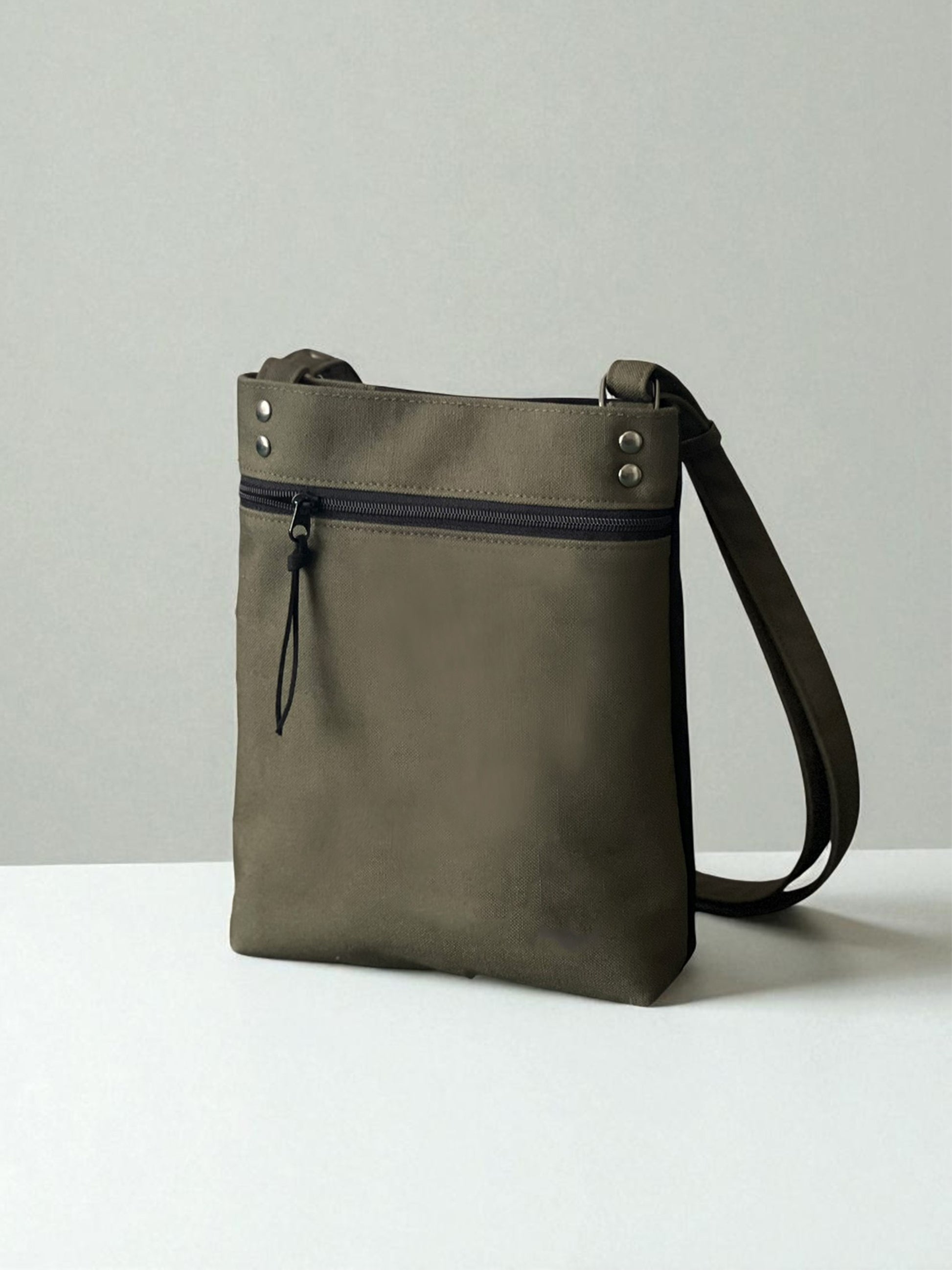 Back of dark olive and black crossbody bag with zipper pocket, handmade by NUIdesign.