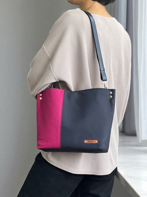 NUIdesign tote bag in Midnight and Fuchsia Rose, worn on the shoulder, slow-crafted in Melbourne.