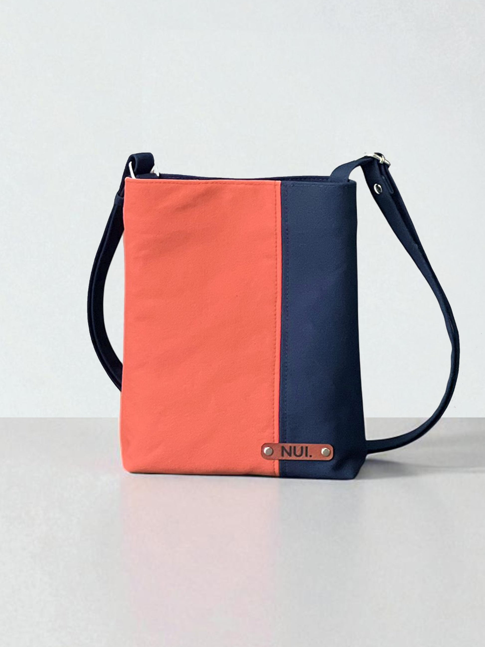 Deep navy base with a fresh coral panel. Handmade crossbody bag in cotton canvas with NUIdesign label.