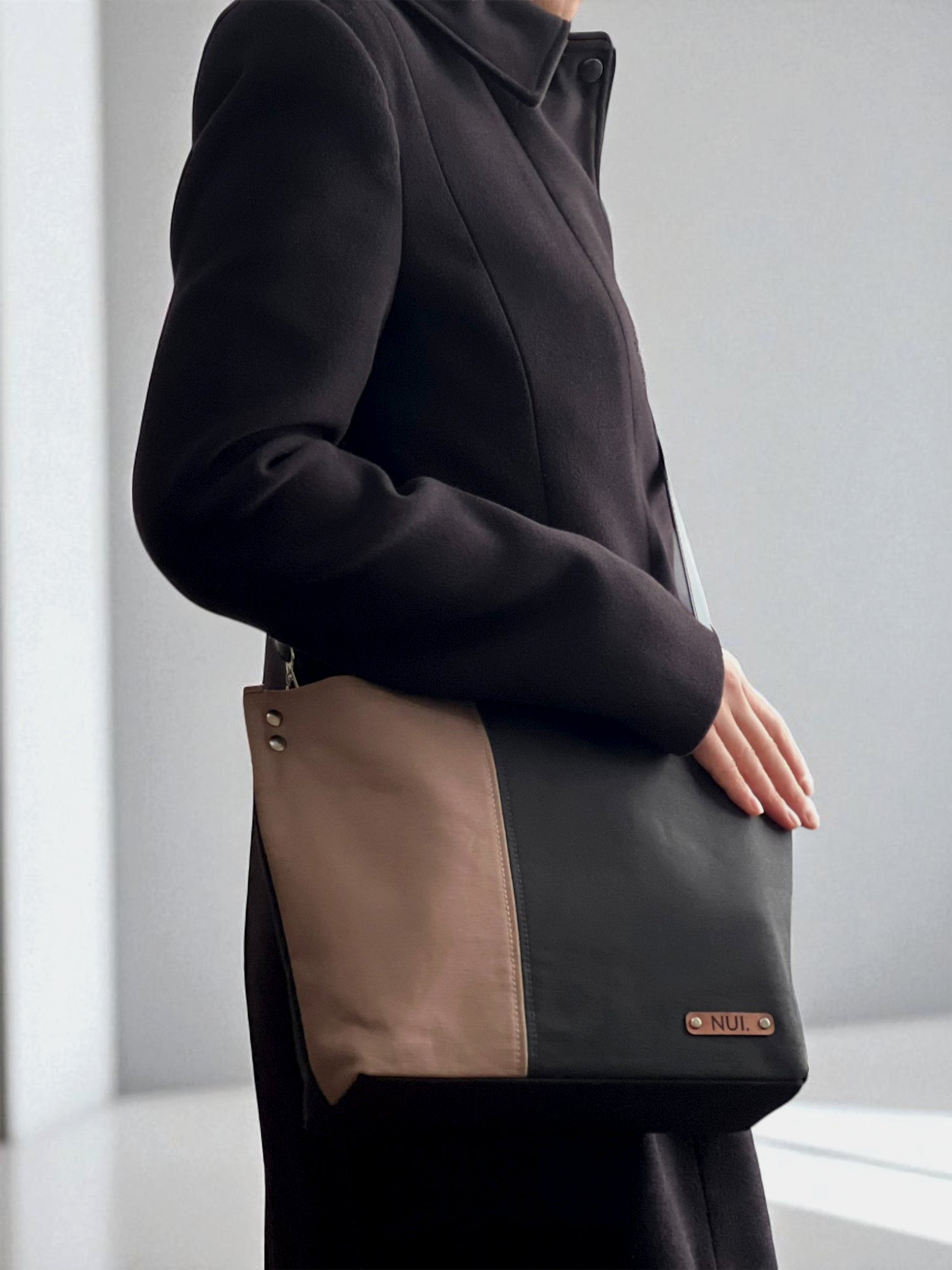 Model wearing the NUIdesign Black × Wild Mushroom tote as a crossbody bag, handmade from Japanese cotton canvas.